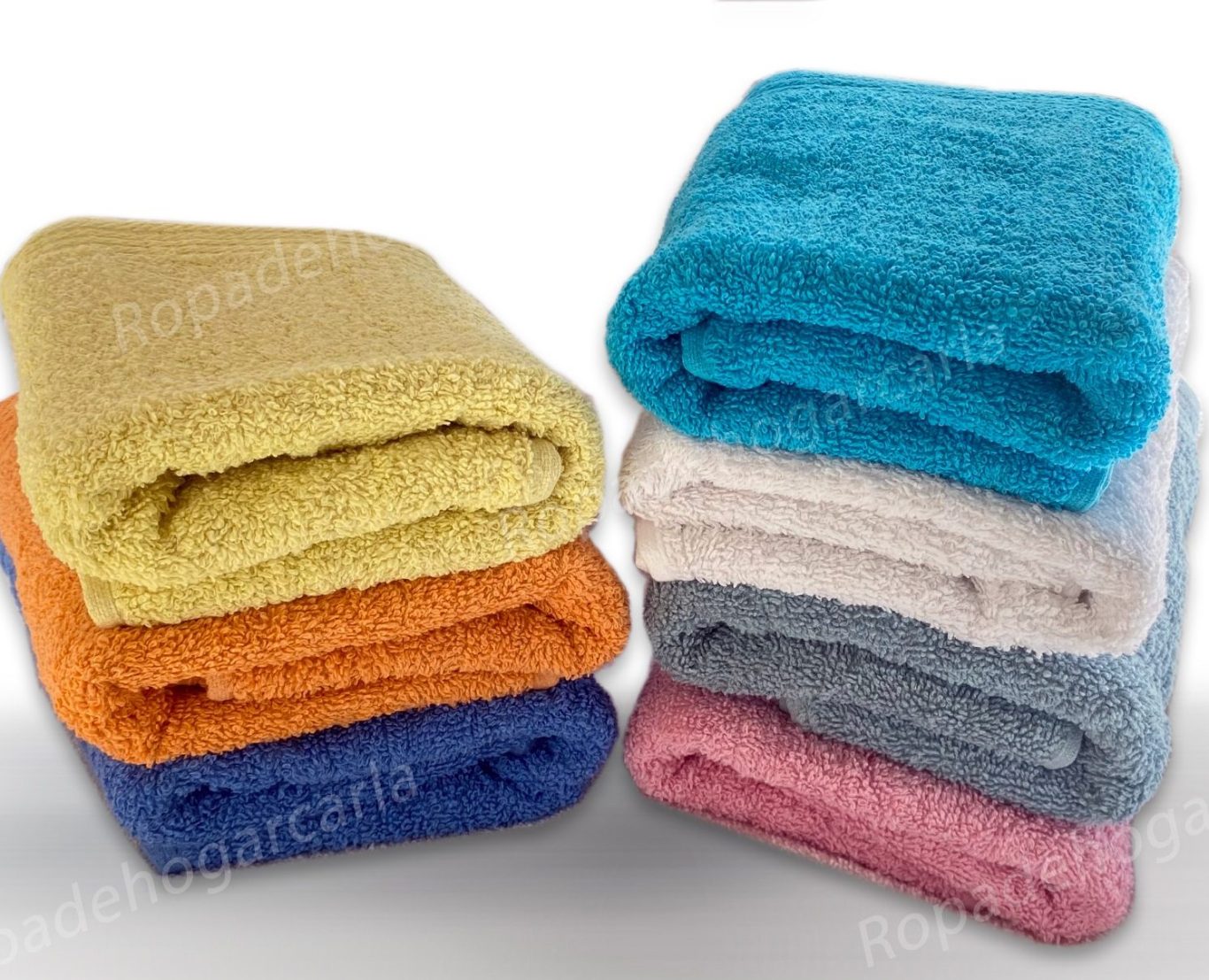 Toallas sueltas de algodón Toallas de colores apiladas: naranja, amarillo, azul, rosa, gris y beige.