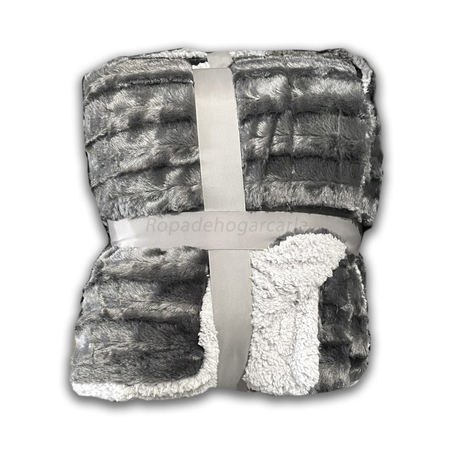 Manta suave y acogedora en tonos gris, atada con una cinta blanca.