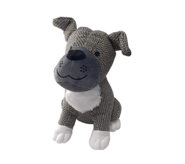 Perro de peluche de color gris con manchas blancas, sentado y sonriente.